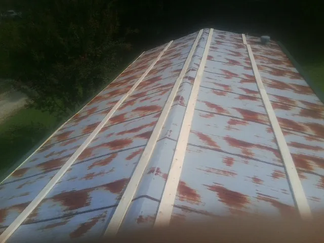 Rusted metal roof panels with new wood purlins before replacement — Storm Damage Roof Repair in Umpqua by Roofing Brothers